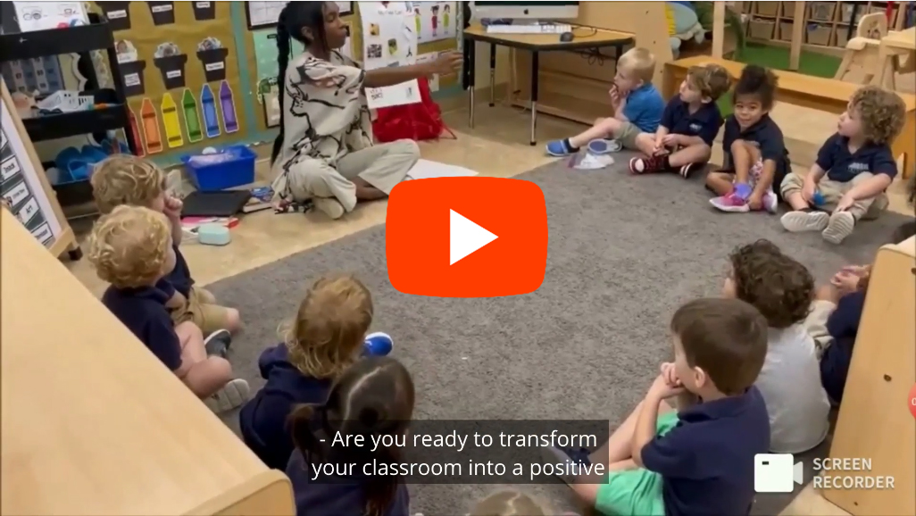 children sitting on floor with teacher